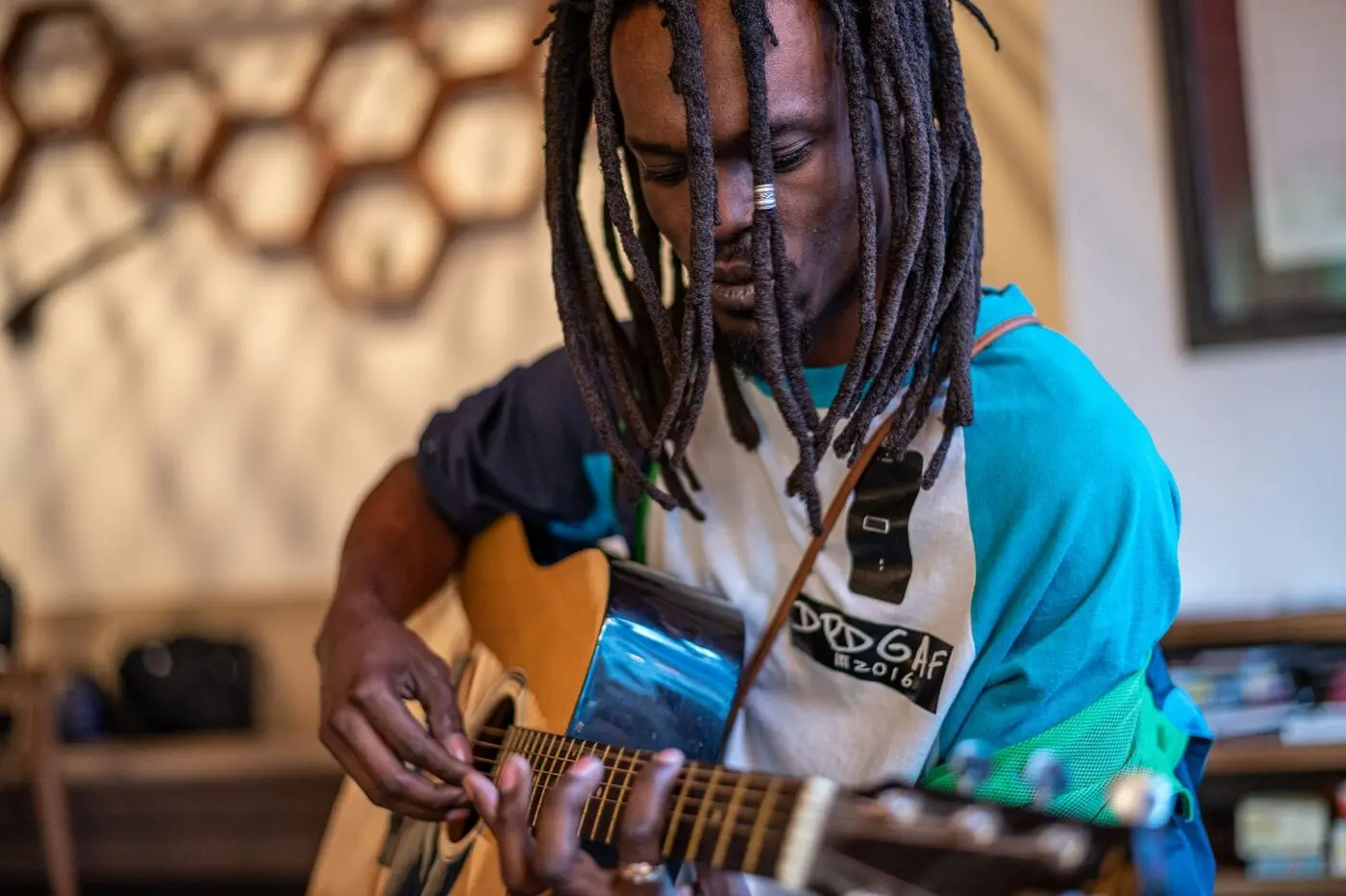 Musician practising guitar in a home studio