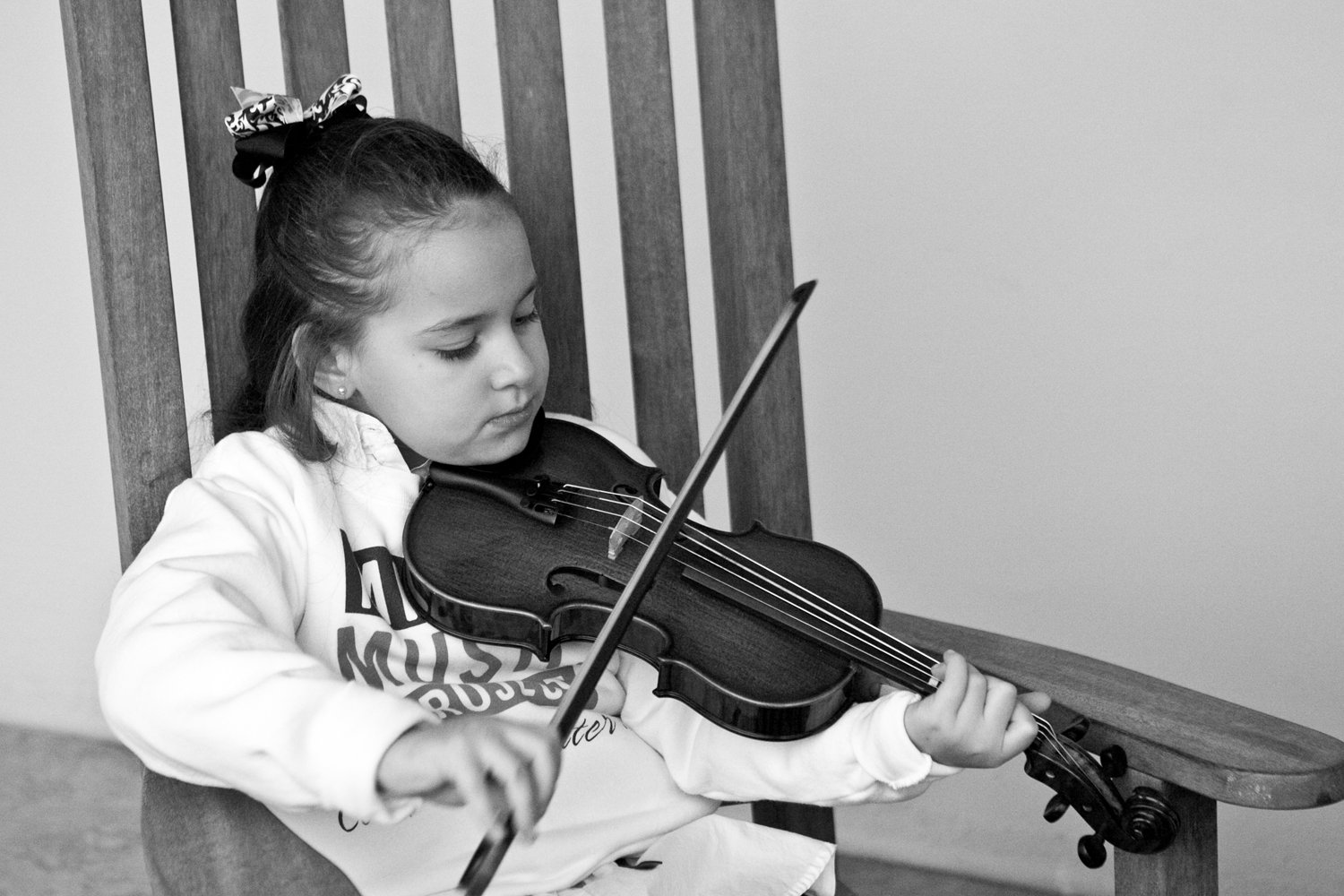 Young student practicing violin during a music lesson