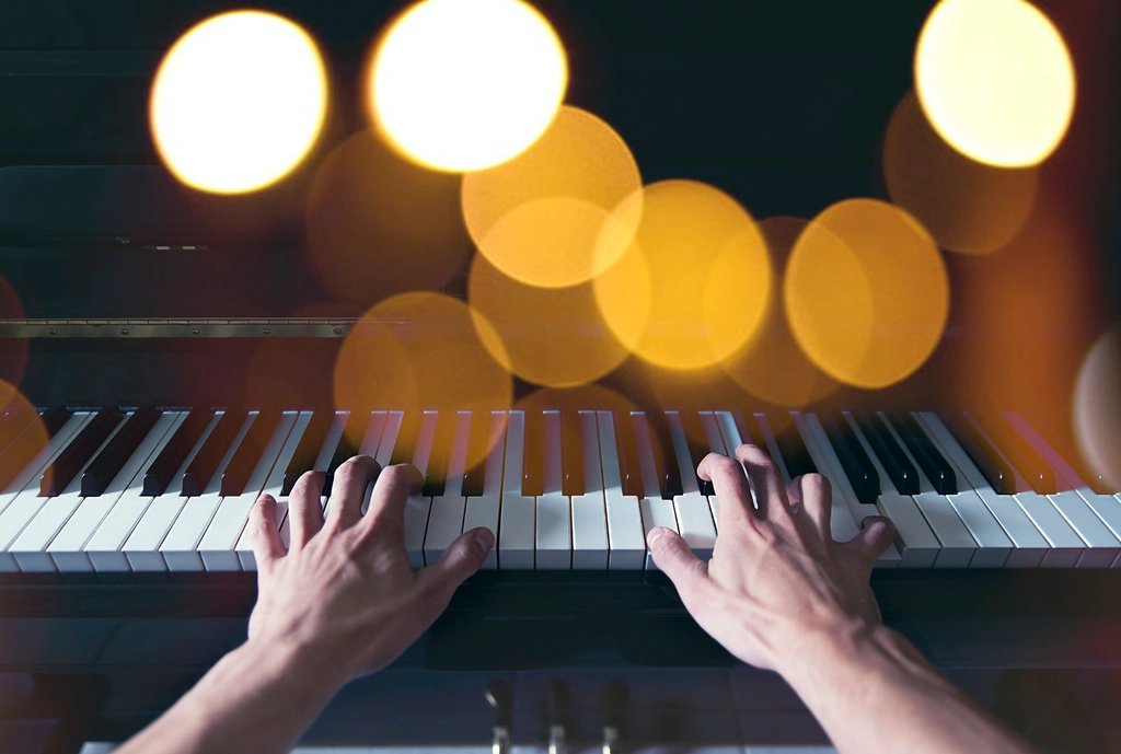 Hands playing piano keys during a music lesson