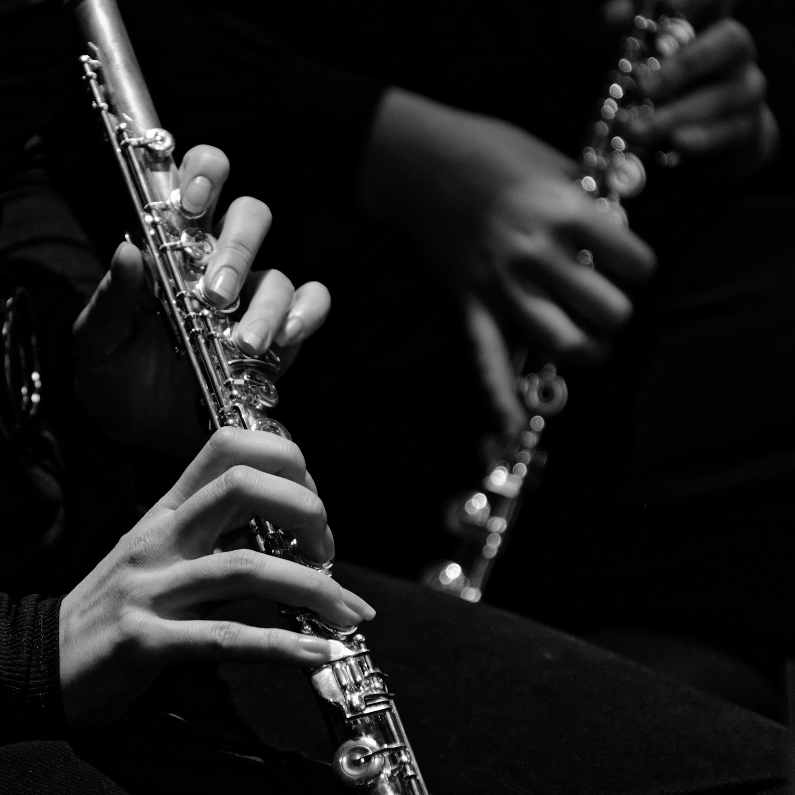 Hands holding a flute during ensemble practice