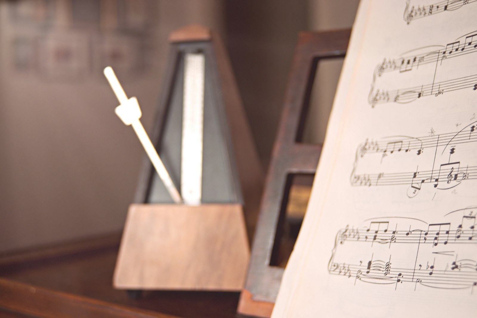 Metronome beside sheet music on a practice stand