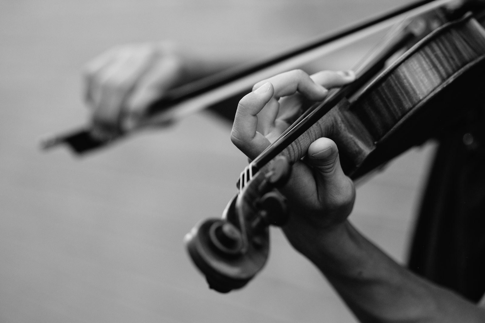 Violinist's hands positioned on the fingerboard mid-lesson