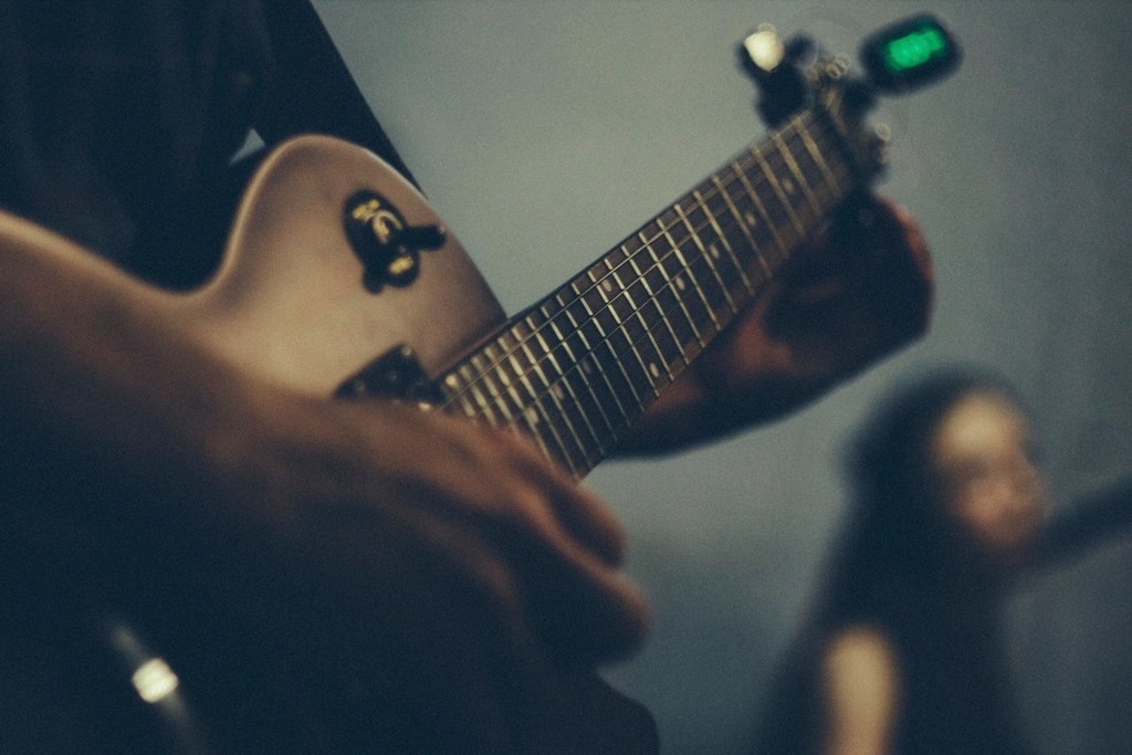 Close-up of hands playing an acoustic guitar