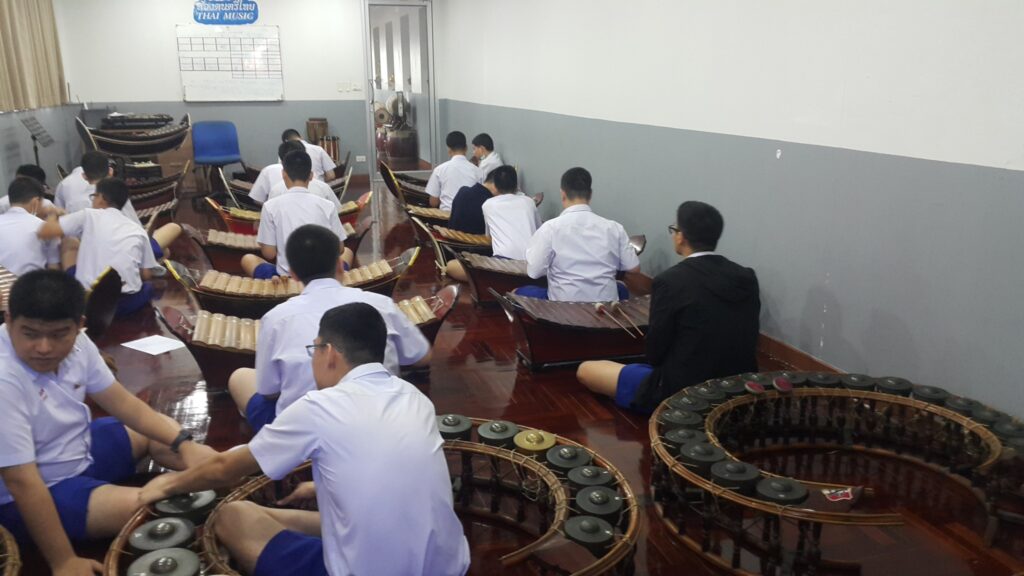 Students seated together practicing in a music classroom