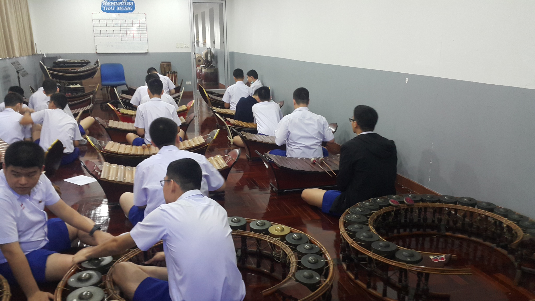 Students seated together practicing in a music classroom